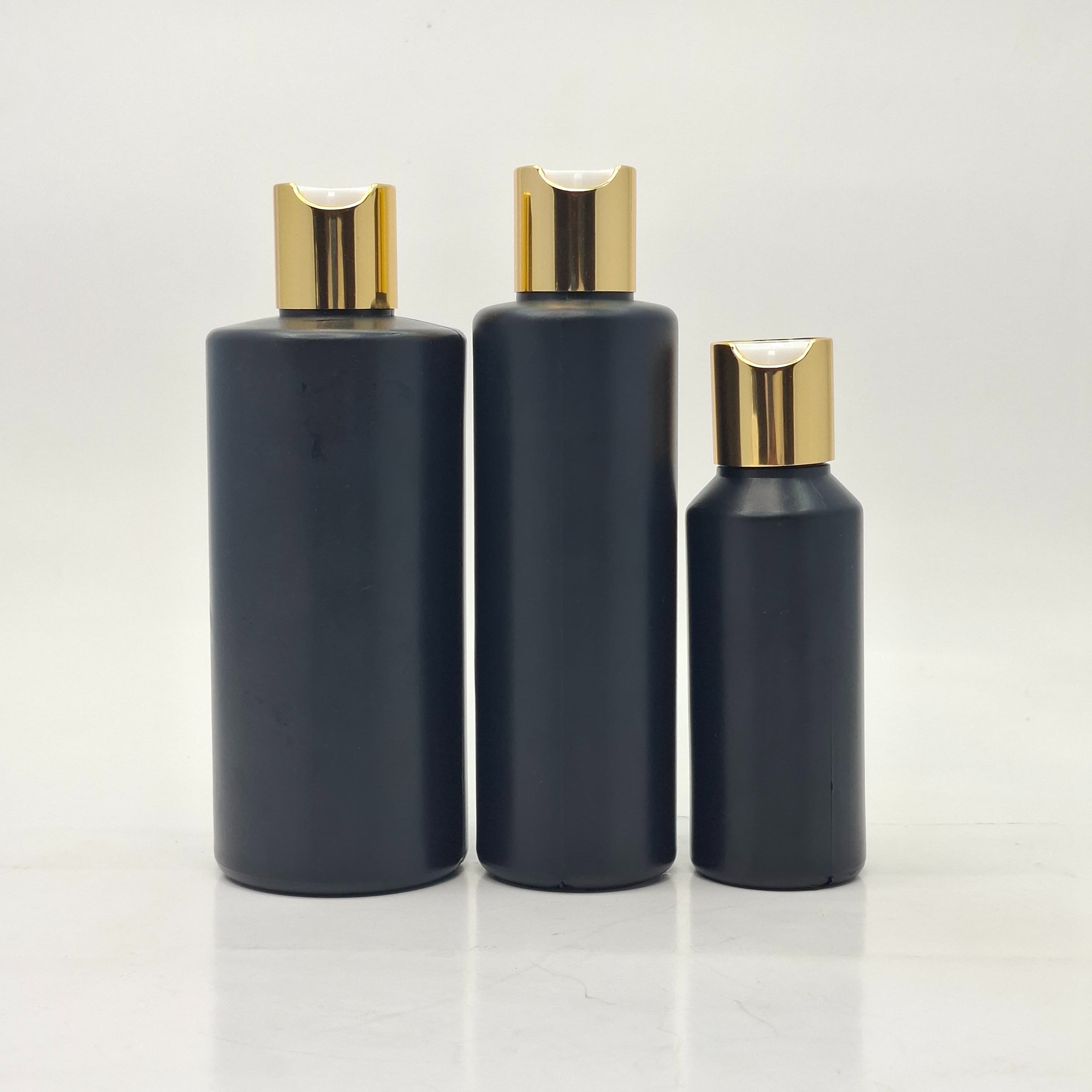 Main image of Round HDPE Black Bottle - Press Lid Gold