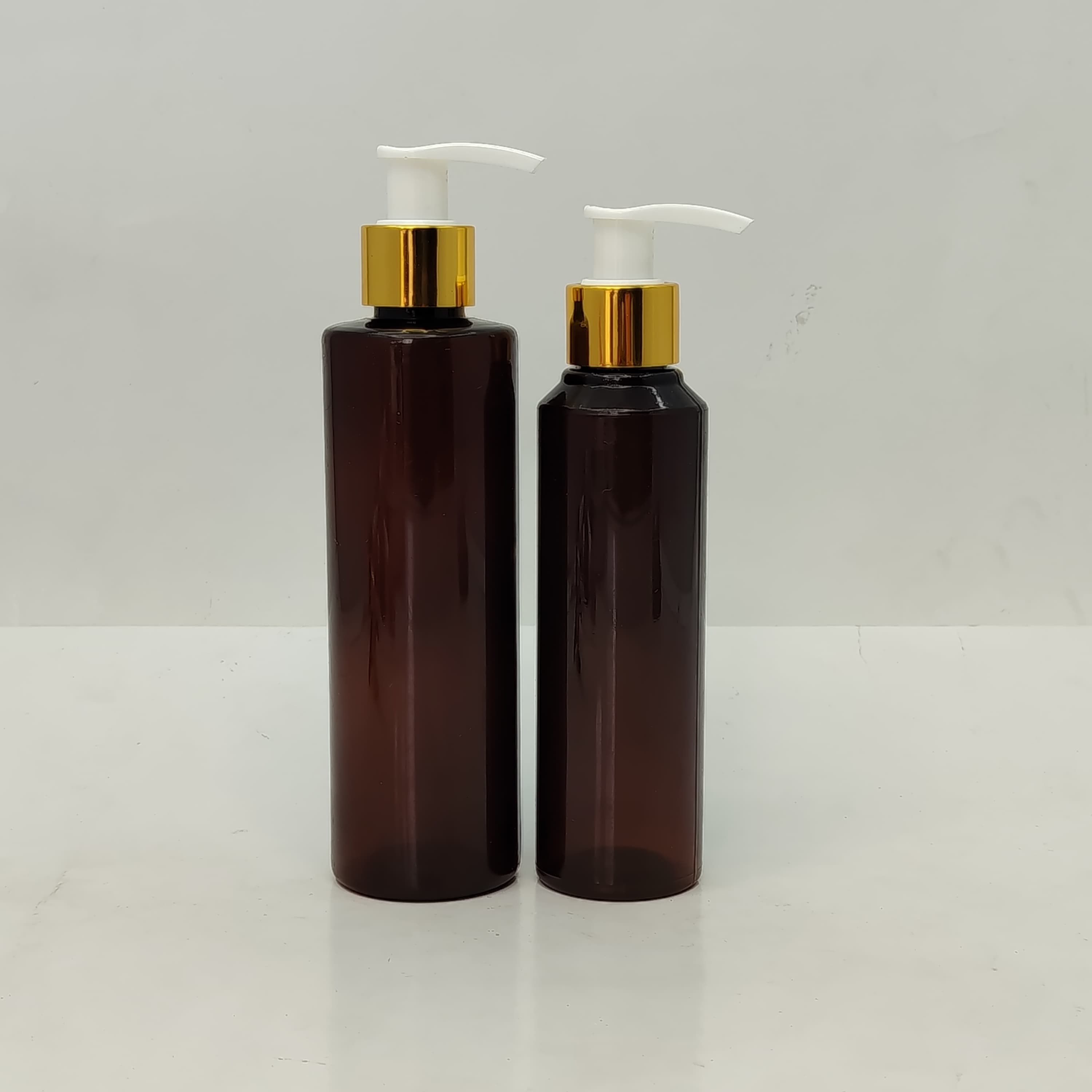 Main image of 150ml-200ml Round Amber Bottle - Gold White Pump