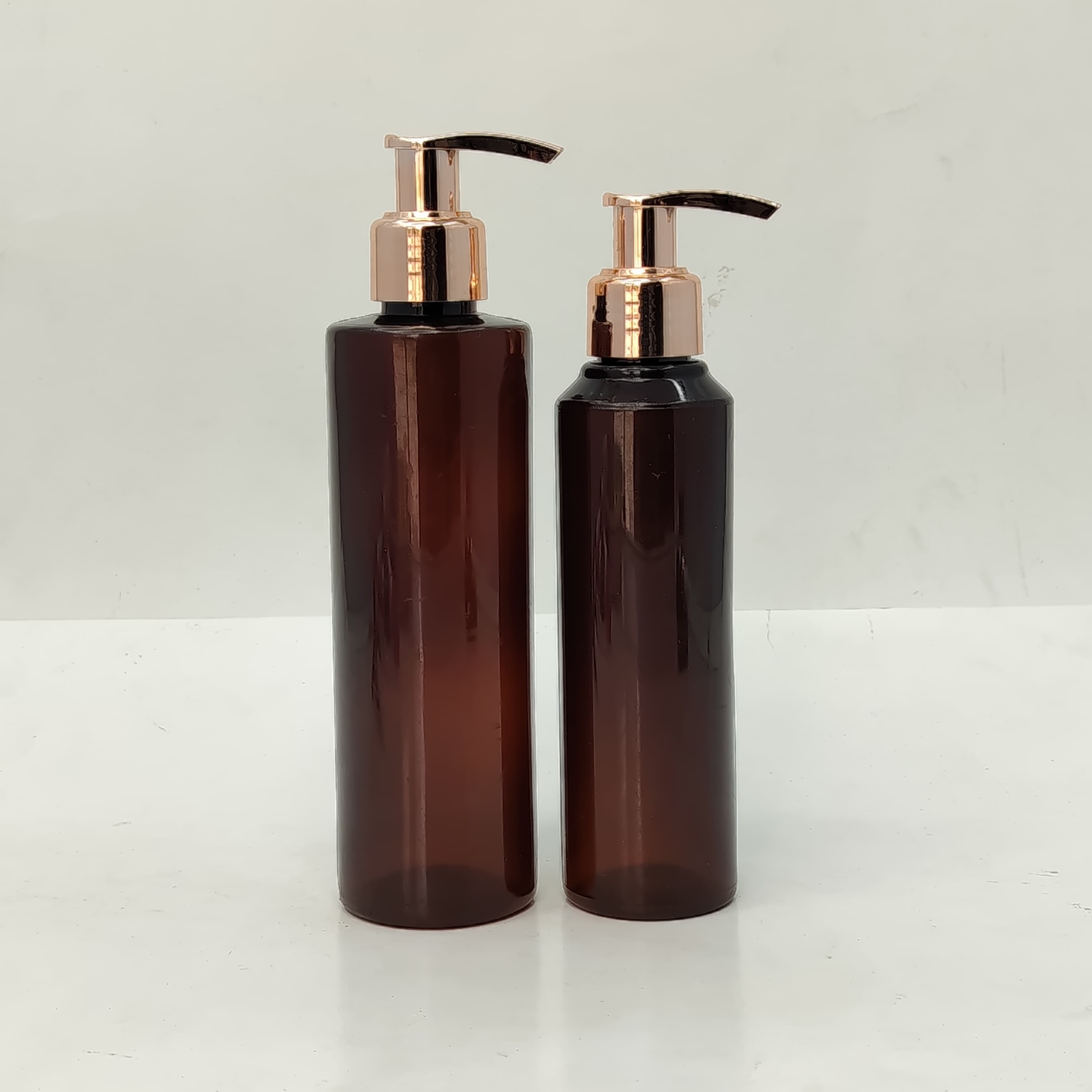 Main image of 150ml-200ml Round Amber Bottle - Rose Gold Pump