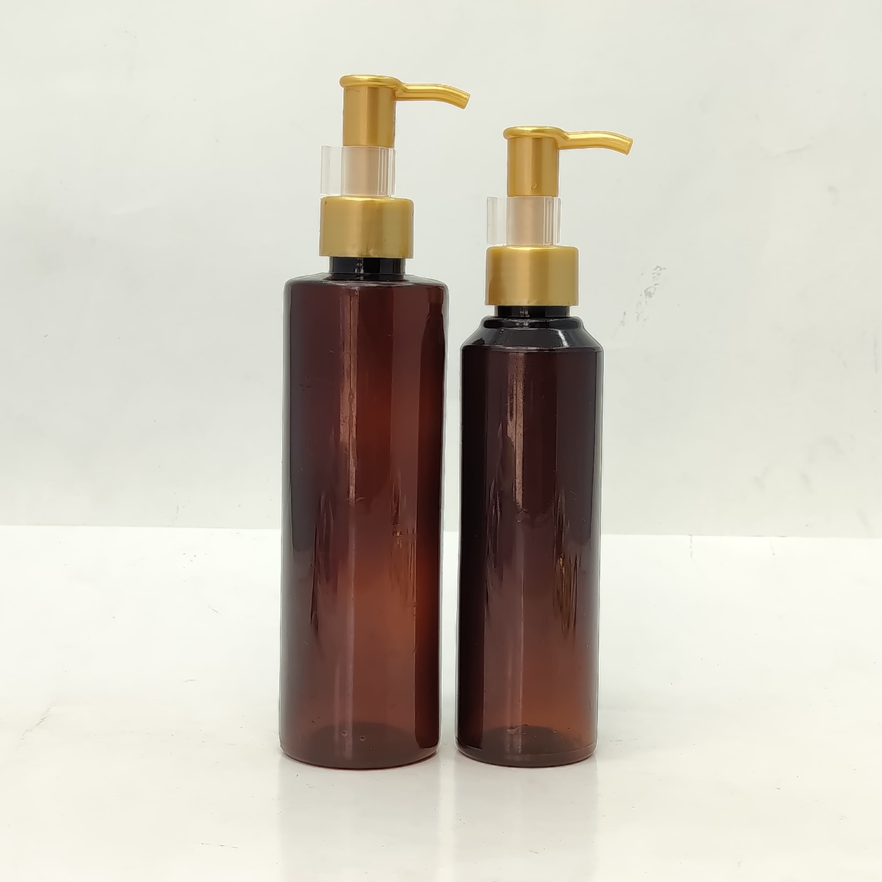 Main image of 150ml-200ml Round Amber Bottle - Gold Cream Pump-Long Neck
