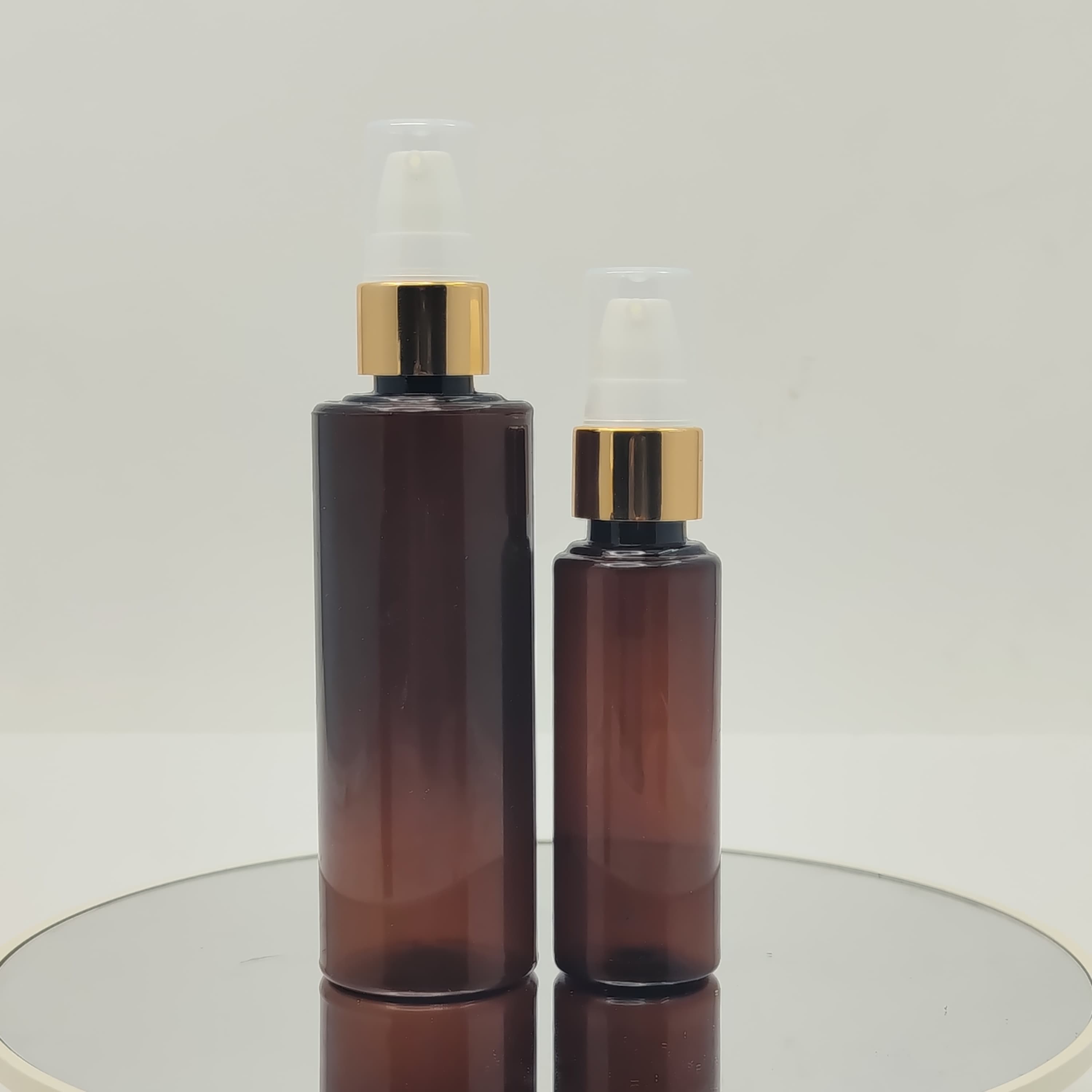 Main image of 50ml-100ml Round Bottle Amber - Drop Pump Gold